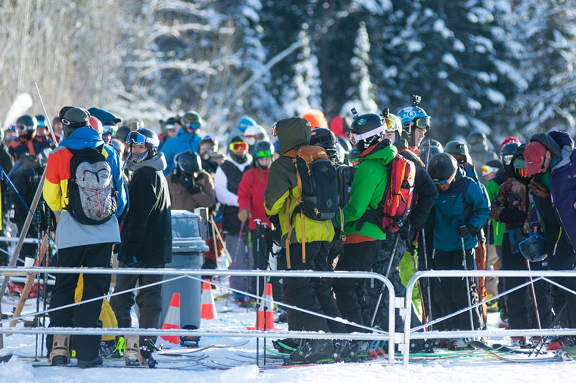 Skiers and snowboarders wait in line for first chair during opening day at Whitefish Mountain Resort.