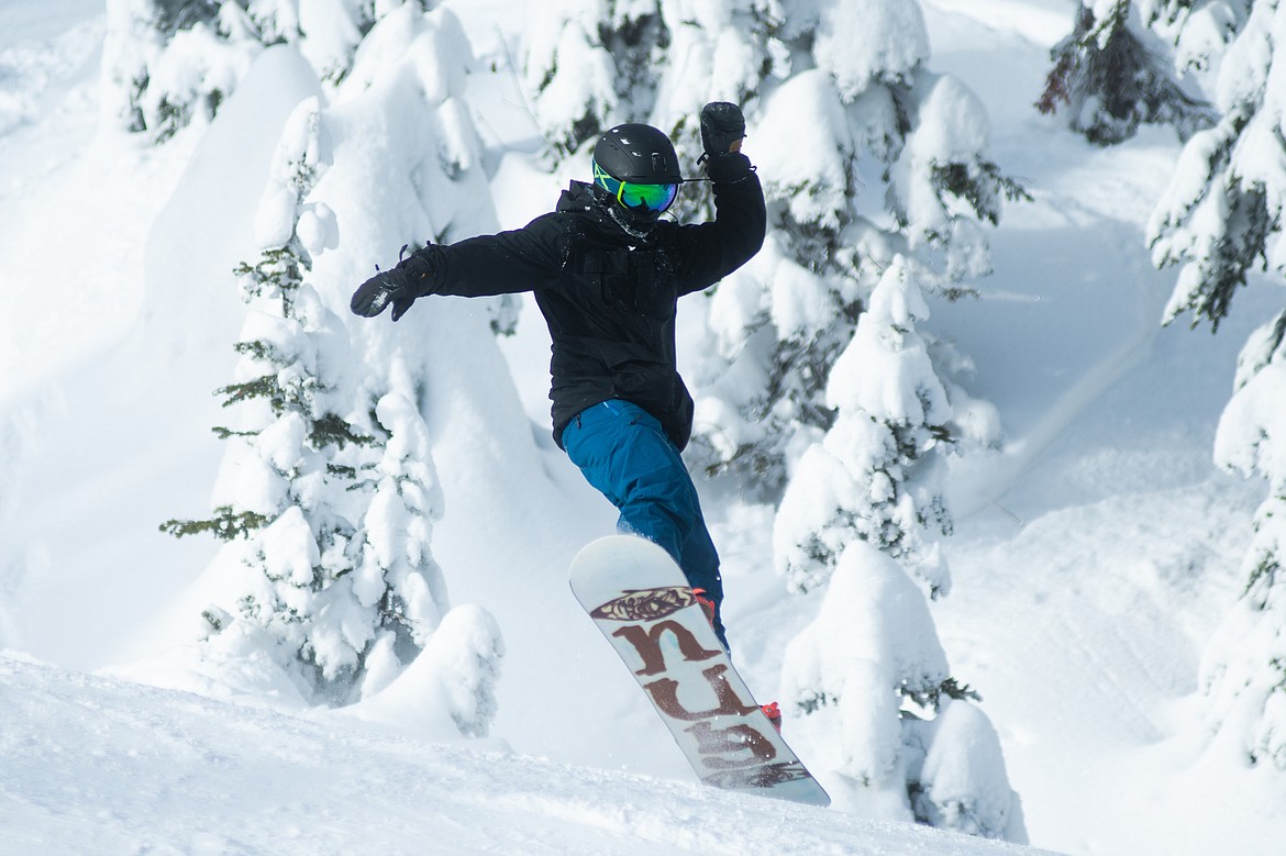 A snowboarder gets some air on Moe Mentum during opening day at Whitefish Mountain Resort.