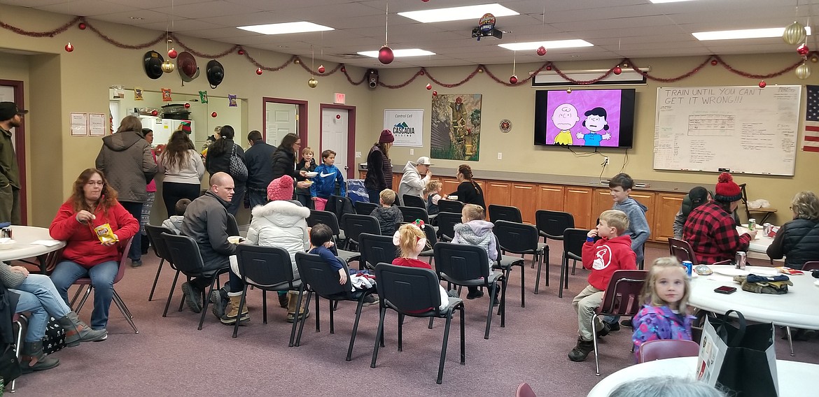 Photo by MANDI BATEMAN
Children watching holiday movies in the South Boundary Fire station.