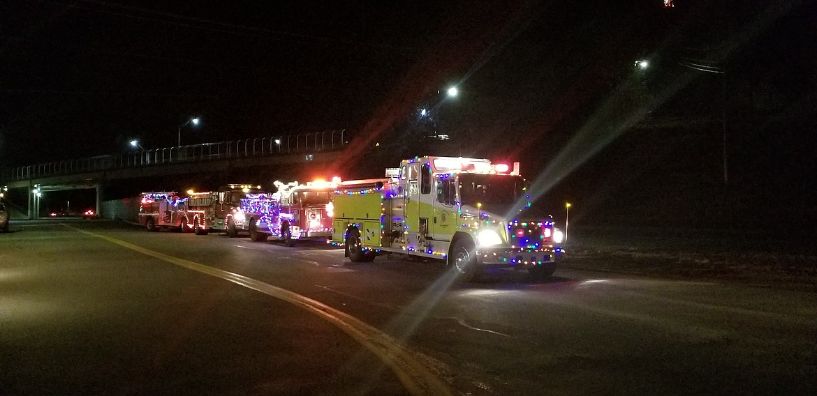 Photo by MANDI BATEMAN
Brightly decorated fire engines from South Boundary, Paradise Valley, Bonners Ferry, and North Bench parked on Bonners Ferry while Santa Claus visited with children.