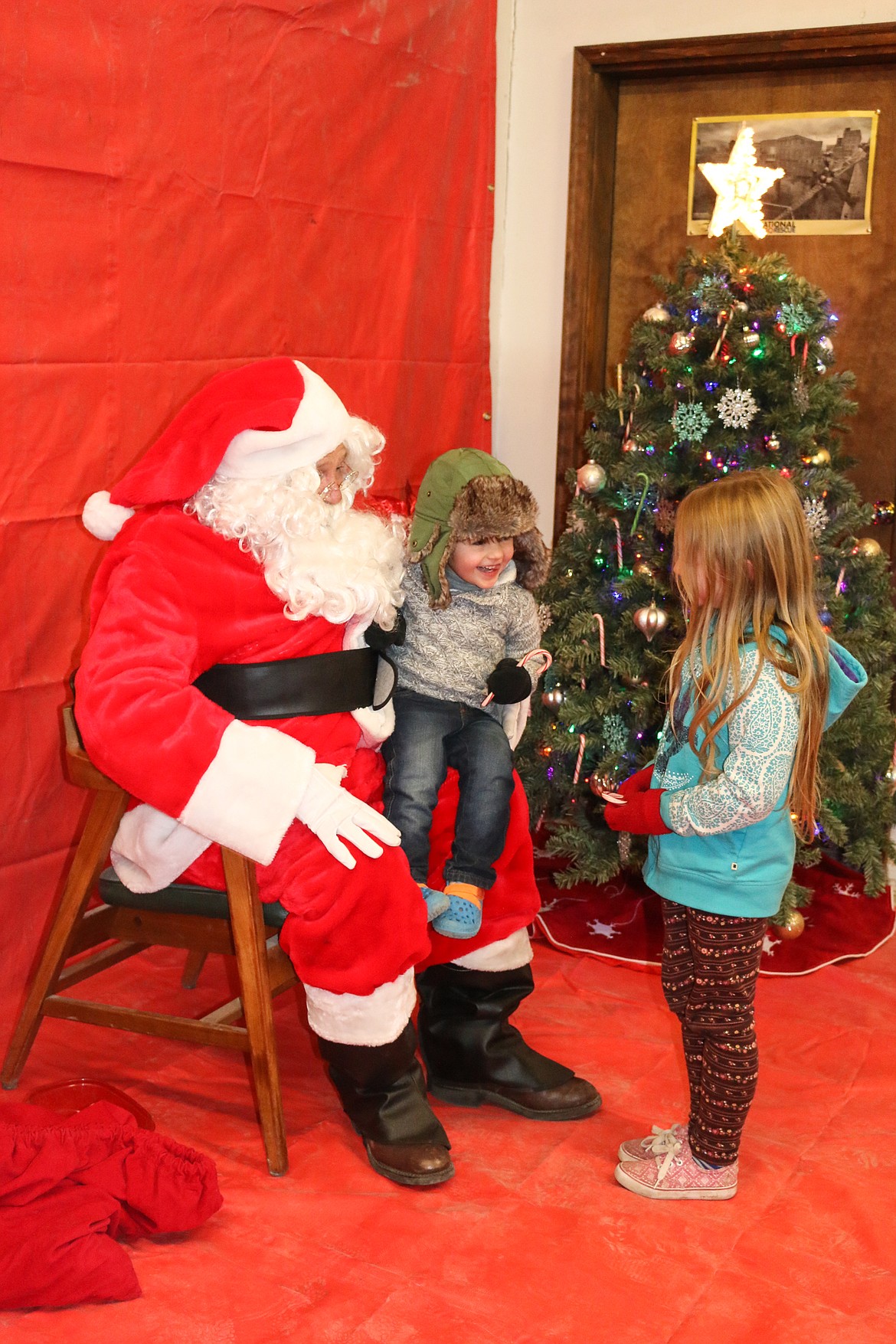 Photo by MANDI BATEMAN
Six year old Aubrey Bethke and her brother, three year old George Bethke, meet with Santa at North Bench Fire station.