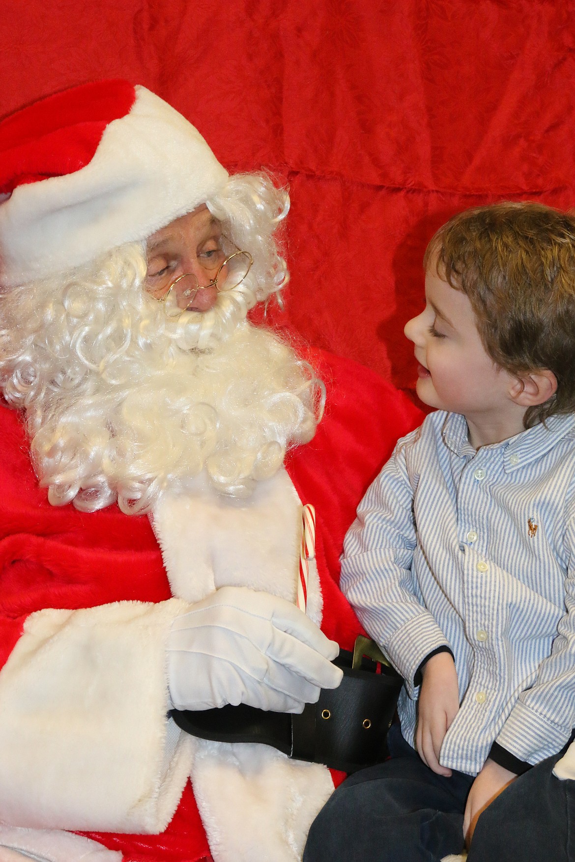 Photo by MANDI BATEMAN
Four year old Weston Keefe talks with Santa during his Chariots of Fire tour.