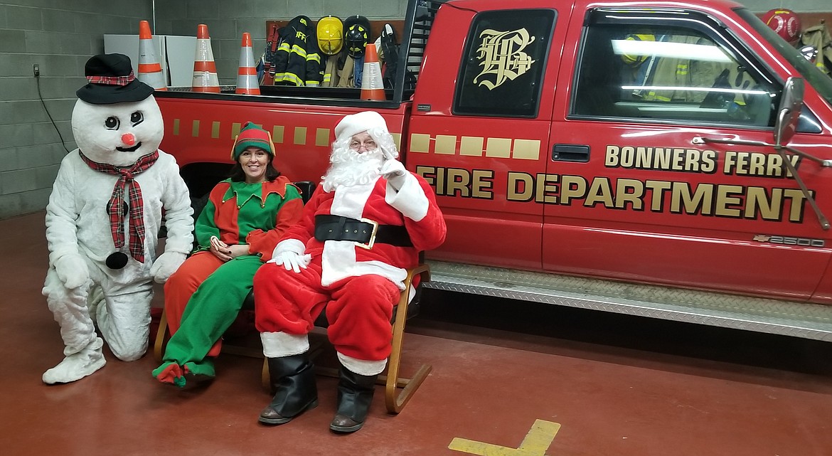 Photo by MANDI BATEMAN
Frosty the Snowman, one of Santa&#146;s elves, and Santa at the Bonners Ferry Fire station.