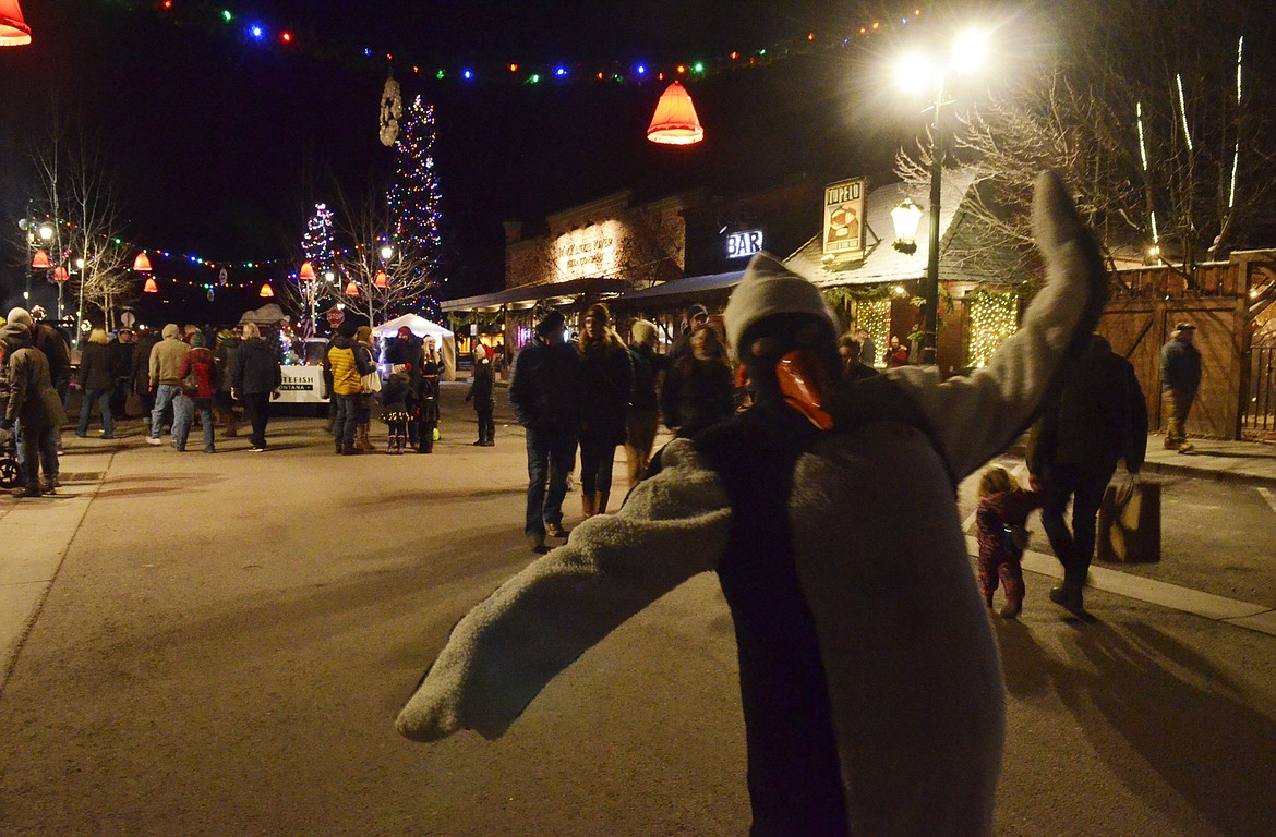 A Winter Carnival penguin dances down Central Avenue during the annual Whitefish Christmas Stroll. (Heidi Desch/Whitefish Pilot)