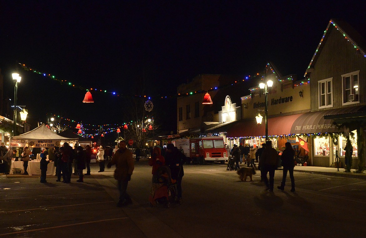 Folks walk Central Avenue Friday night during the annual Christmas Stroll.