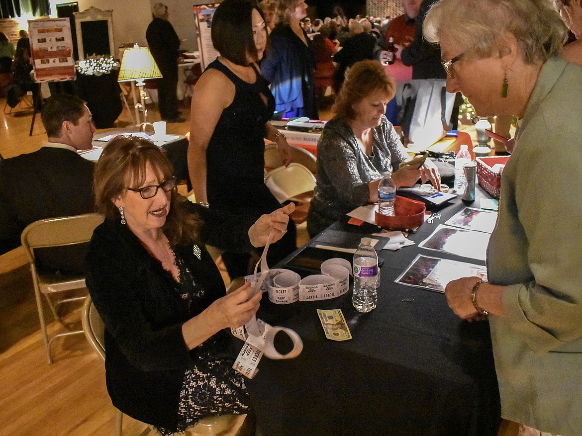 Paula Schauss counts out raffle tickests in the Libby Memorial Events Center Saturday during the annual Festival of Trees Fundraising Gala for the Cabinet Peaks Medical Center Foundation (Ben Kibbey/The Western News)