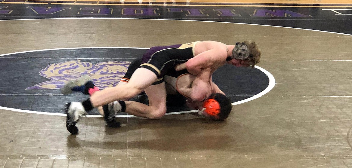 Wildcat Juddson Hall attempts to roll his Eureka opponent over during their match in the dual portion of the George Wild Tournament.