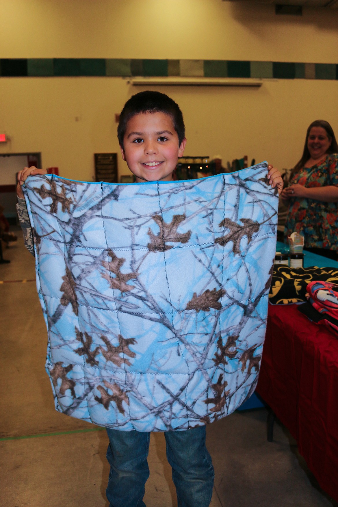 Photo by MANDI BATEMAN
Nine year old Colt Moore shows off a weighted blanket that he helps his mom make at the Naples Holiday Festival Craft Fair.