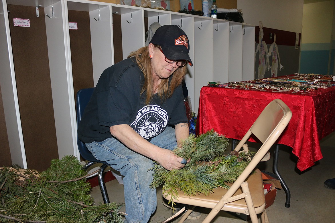 Photo by MANDI BATEMAN
Dawn Thompson working on one of her wreaths at the Naples Holiday Festival Craft Fair.