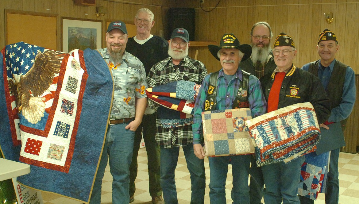 U.S. veterans who received Quilts of Valor from Joint Operations Mariposa last Saturday evening at the Horse Plains VFW Post 3596 are, front row from left, Charles Forman, Gary Jenson, Ron Chisenhall and Bob Kunch; and back row, James Gillibrand, Ronald Kilbury and Jimmie Allison. Otto Otnes and Daren King, who were unable to attend, also received quilts. Ed Foste and Dave Williams of Joint Operations Mariposa presented the quilts preceding the flag retirement ceremony outside the VFW. (Joe Sova photos/Clark Fork Valley Press).