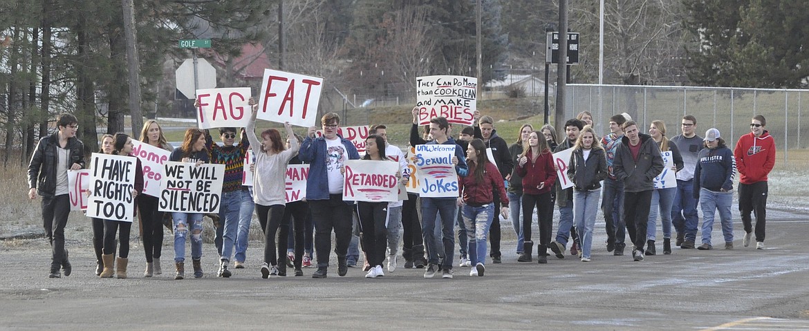 A group of high school students from Thompson Falls hold up signs during a protest Tuesday, Dec. 4. Some signs contained racial and gender slurs that have allegedly been said to students by students. (Ashley Fox/Lake County Leader)