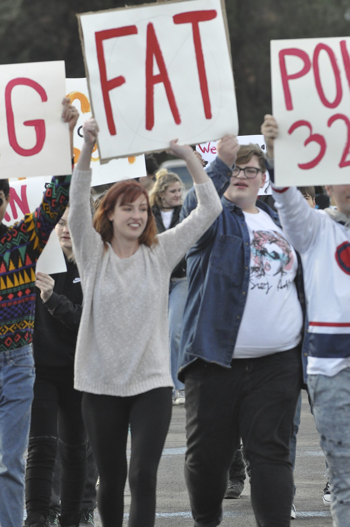 Thompson Falls High School senior Trinity Godfrey, center, holds a sign during a protest last week which she helped organized after alleging harassment from peers. (Ashley Fox/Lake County Leader)