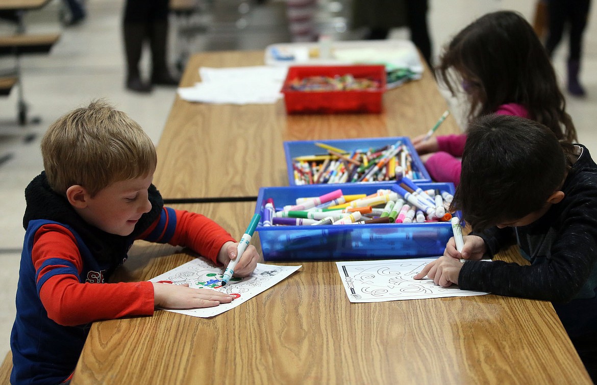Theodore Serticchio, JJ Charland, and Kalleigh Anaya color festive pictures during School PLUS at Ramsey Magnet School of Science on Friday. (JUDD WILSON/Press)