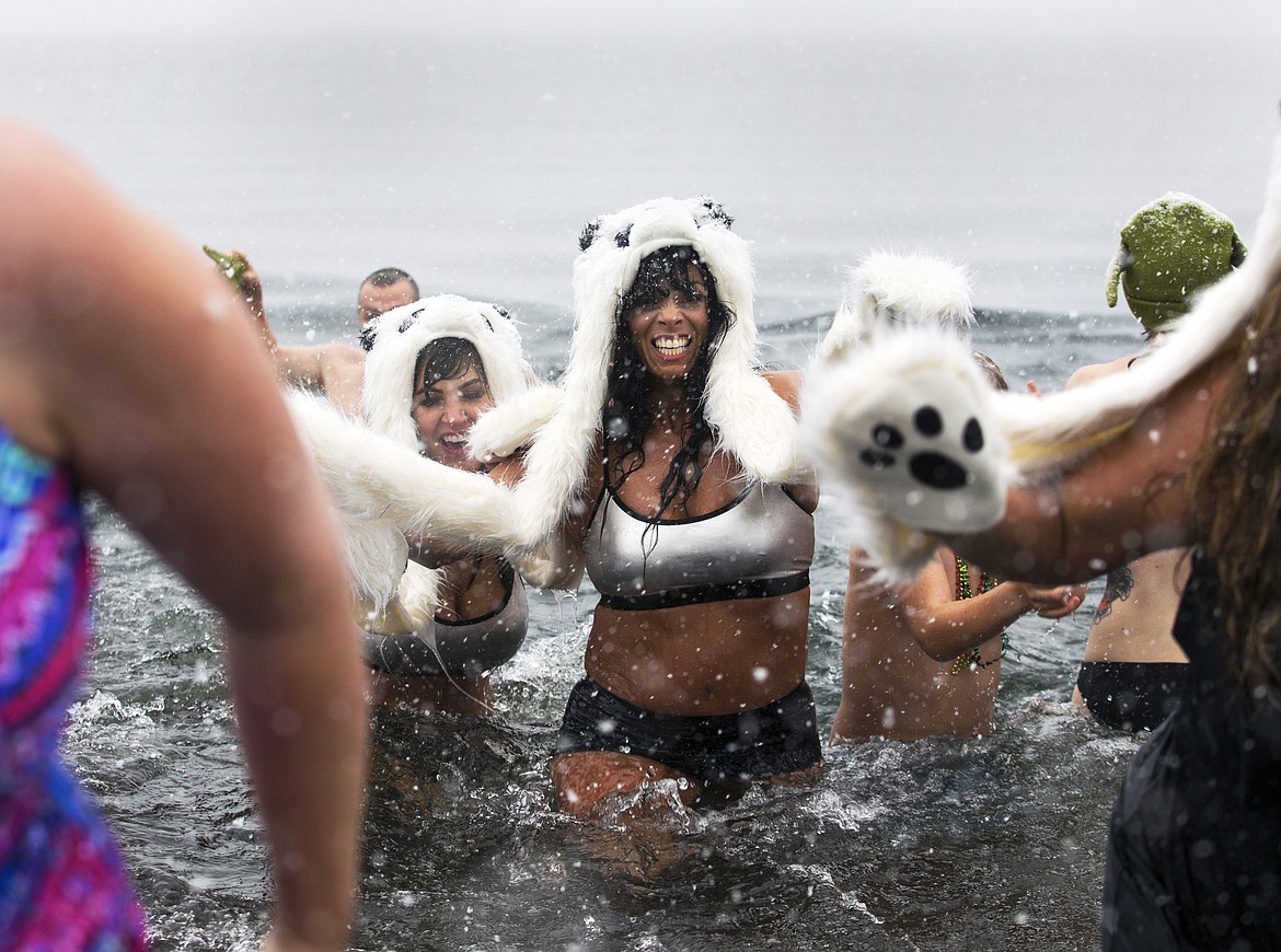 LOREN BENOIT/Press file
Stacy Benoscek, decked out in polar bear attire, rushes back to the beach during the annual Polar Bear Plunge at Sanders Beach in January 2017.