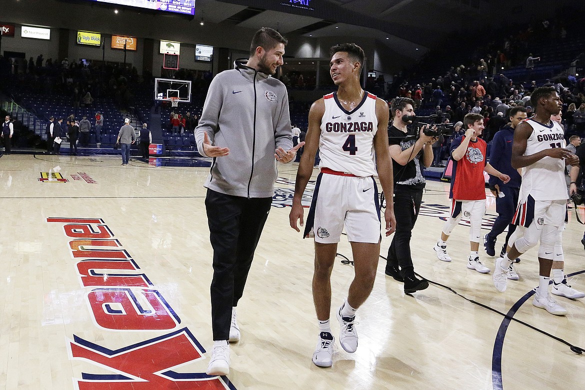YOUNG KWAK/Associated Press
Injured Gonzaga star Killian Tillie, left, here walking off the floor with teammate Greg Foster Jr. after last Tuesday&#146;s game vs. Texas-Arlington, is on track to return &#147;sometime in January,&#148; Bulldogs coach Mark Few says.