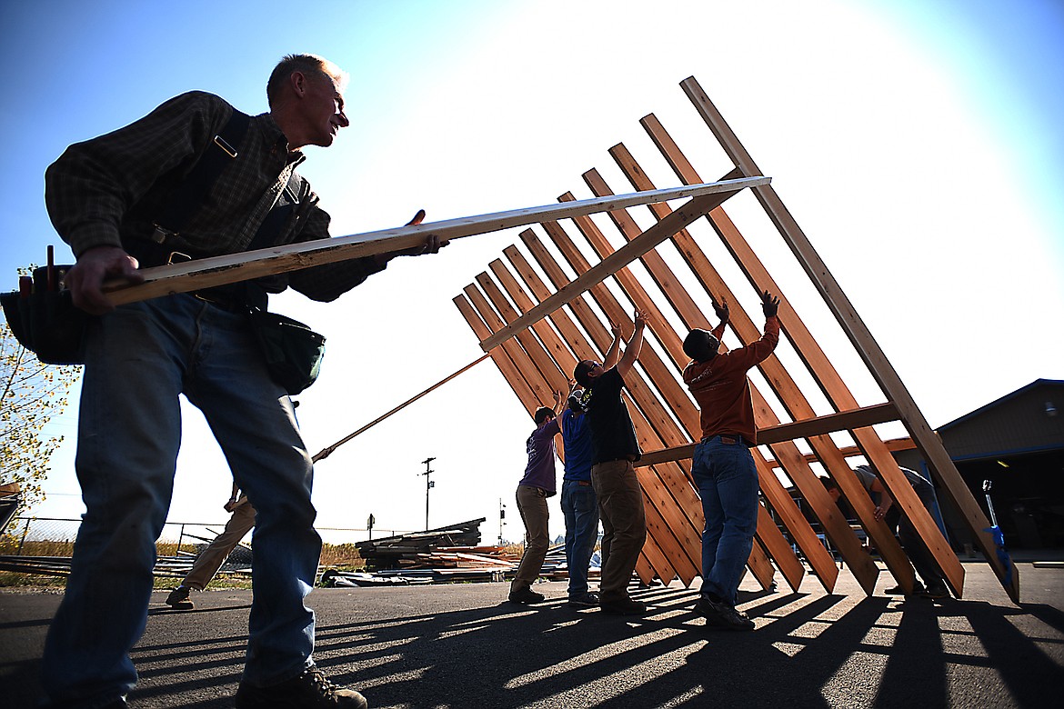 Left, community volunteer Jim Bengtson, and students in the University of Kentucky Material and Methods class raise the frame of the sign that will be set up to mark the one mile West Valley Loop, on Wednesday, September 30, 2015. The class, which is taught by Ryan Hargrove, is held once a year and includes a service project that lets students use some of the things they have learned in College of Agriculture, Food and Environment and apply them in the field. The crew from UK arrived on Tuesday and will fly out on Monday.(Brenda Ahearn/Daily Inter Lake)