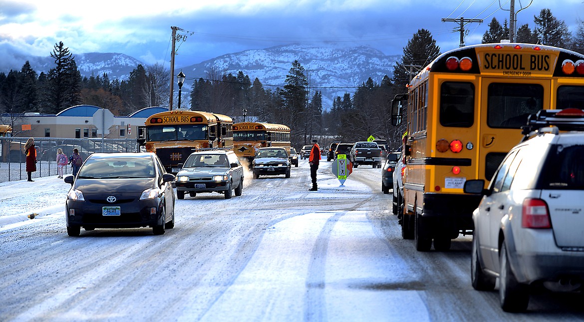 Cars and buses navigate the intersection of East Seventh Street and Ashar Avenue in Whitefish on March 18, 2013. Construction of a new elementary school funded by a $26.5 million bond issue passed in 2017. (Brenda Ahearn/Daily Inter Lake)