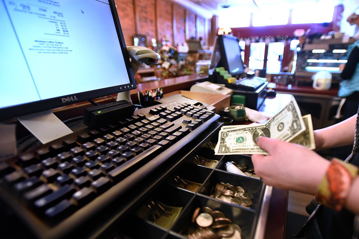 Bryce Swanson makes change for a customer at Montana Coffee Traders in downtown Whitefish on Jan. 14, 2016. (Brenda Ahearn/Daily Inter Lake file)