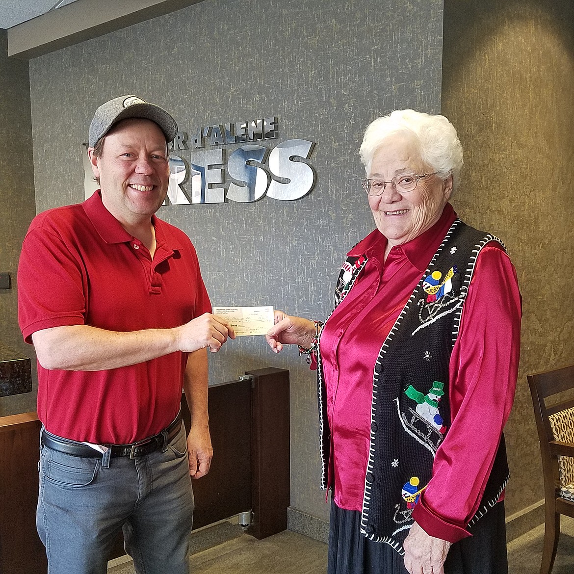 Press reporter Brian Walker accepts a donation to the Christmas for All program on Friday. Treasurer Nancy Morris presented the $500 check on behalf of the Independent Order of Odd Fellows Carnation Rebekah Lodge. (HOLLY PASZCZYNSKA/PRESS)