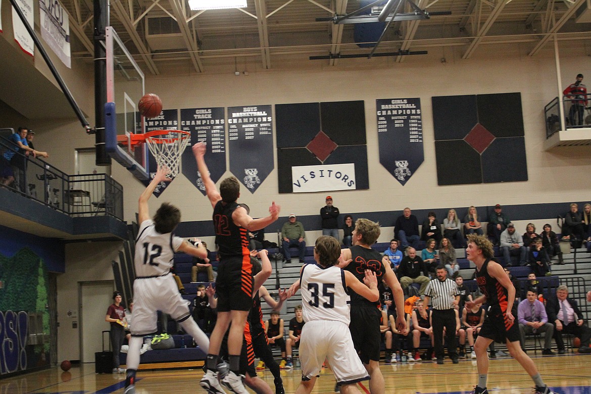 Photo by TANNA YEOUMANS
Dylan Hittle jumps for the score with Matt Morgan watching his back.