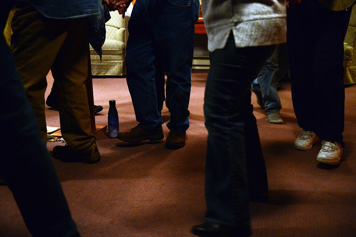 Attendees circle the room while singing, dancing and playing instruments at Dances of Universal Peace at Shining Mountains Center for Spiritual Living in Kalispell on Wednesday, Dec. 19. (Casey Kreider/Daily Inter Lake)