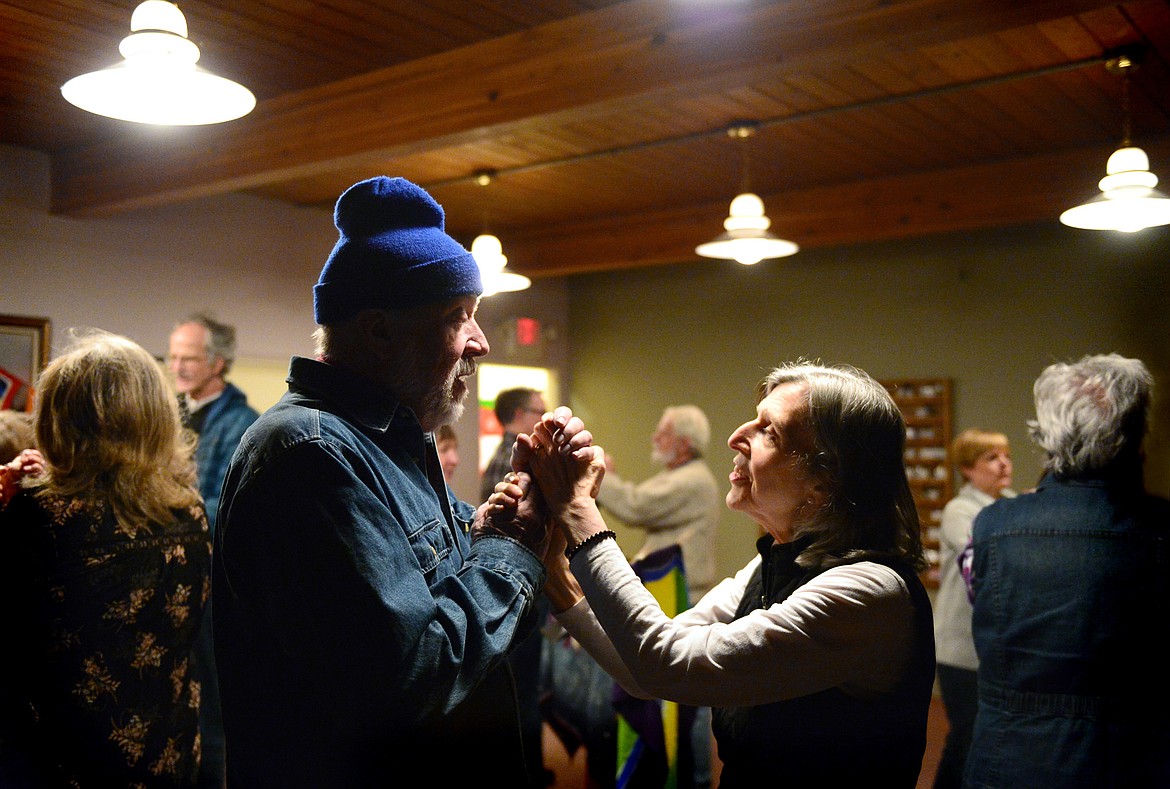 Attendees hold hands and sing songs during Dances of Universal Peace at Shining Mountains Center for Spiritual Living in Kalispell on Wednesday, Dec. 19. (Casey Kreider/Daily Inter Lake)