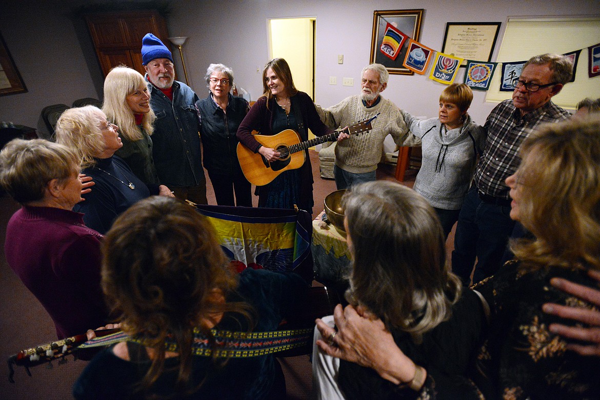 Attendees form a circle while singing, dancing and playing instruments at Dances of Universal Peace at Shining Mountains Center for Spiritual Living in Kalispell on Wednesday, Dec. 19. (Casey Kreider/Daily Inter Lake)