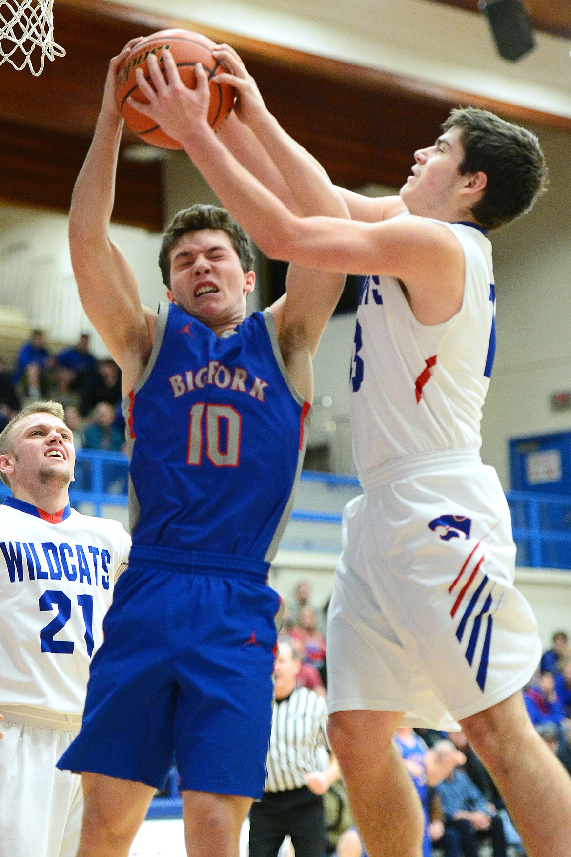 Bigfork's Randy Stultz (10) fights for a rebound with Columbia Falls' Dillon Shipp (13) at Columbia Falls High School on Saturday. (Casey Kreider/Daily Inter Lake)