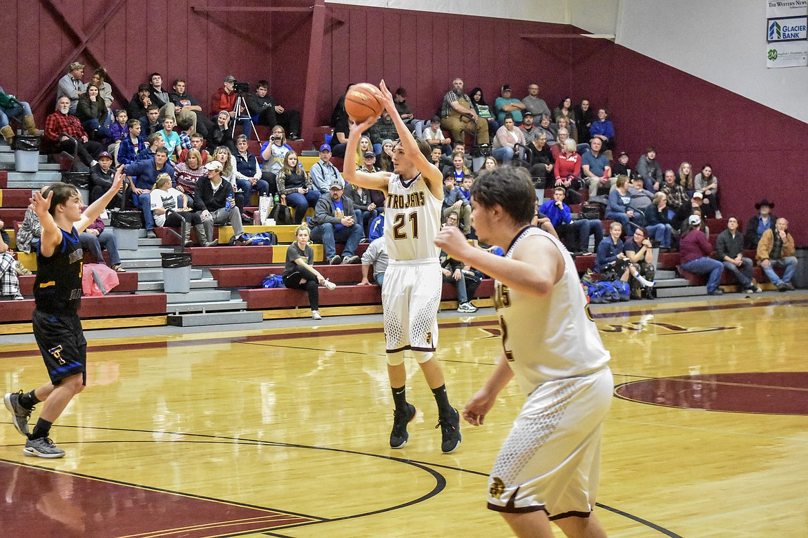 Troy senior Dylan Cummings shoots for three early in the second quarter against Thompson Falls Friday, regaining the Trojan lead 13-11. (Ben Kibbey/The Western News)