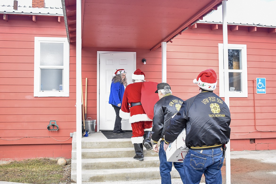 Members of Troy VFW Post 5514 arrive with Santa to distribute candy and stuffed animals at McCormick Elementary School. (Ben Kibbey/The Western News)