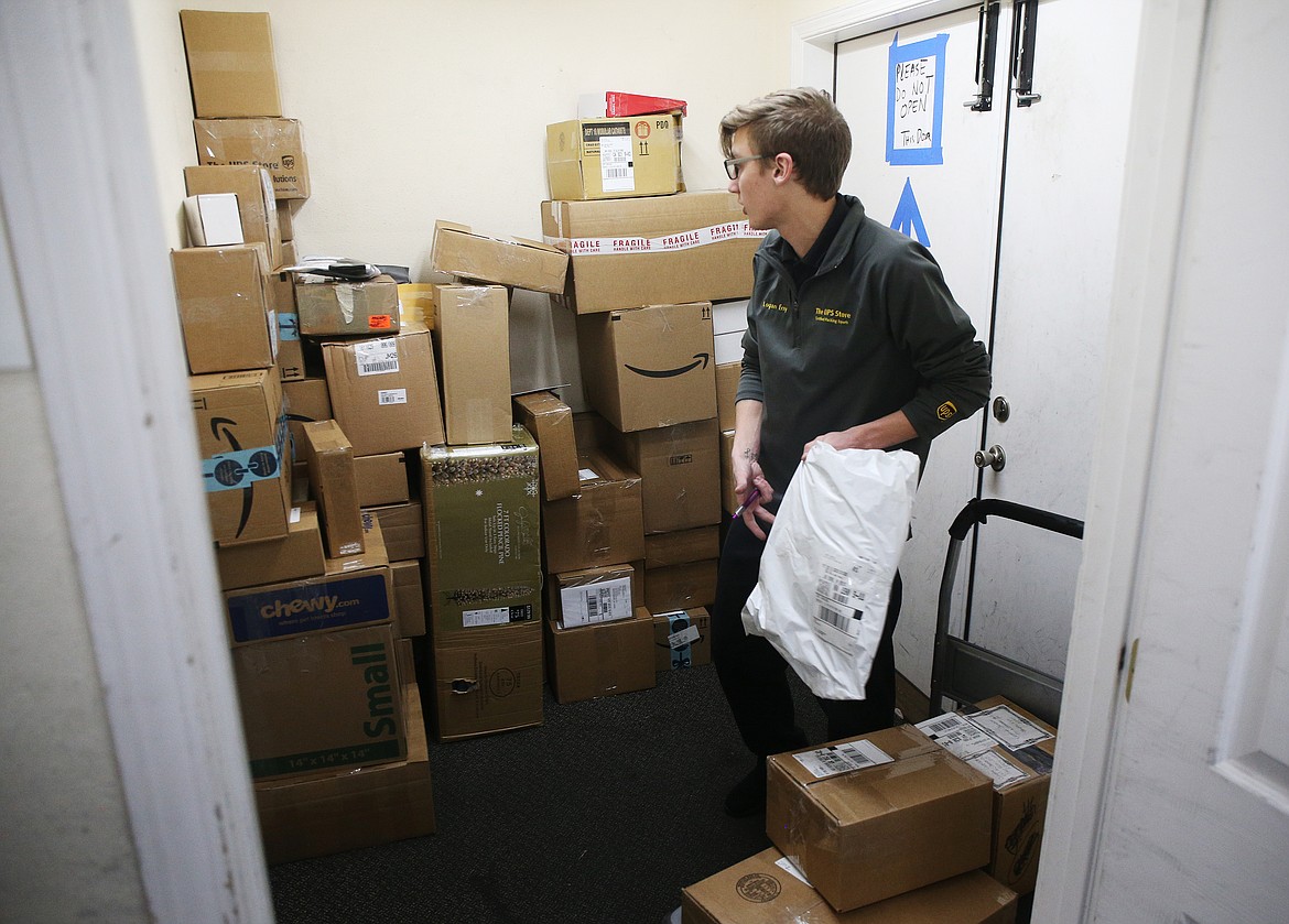 UPS employee Logan Erny organizes packages for two and three day ground shipment Thursday afternoon in Post Falls. (LOREN BENOIT/Press)