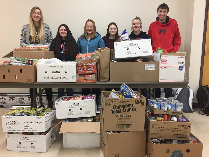 Troy High School Honor Society members pose with food donated to the Troy Food Pantry as part of the honor society&#146;s food drive. Pictured are: Ella Pierce, Honor Society President Emily Ramirez, Mazzy Hermes, Chloe Phillips, Katelyn Tallmadge and Dylan Cummings. (Courtesy photo)