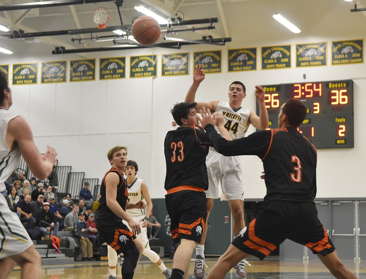 Whitefish&#146;s Lee Walburn looks to make a pass over two defenders to a fellow Bulldog in the third quarter of the Bulldog&#146;s game against Frenchtown at home Dec. 21. (Heidi Desch/Whitefish Pilot)