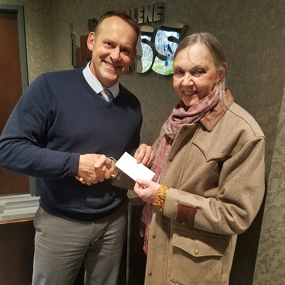 HOLLY PASZCZYNSKA/Press
Linda Rider stopped by The Press offices on Tuesday to drop off a $1,500 donation made by the Kootenai-Shoshone Farm Bureau. Reporter Ralph Bartholdt accepted the donation.