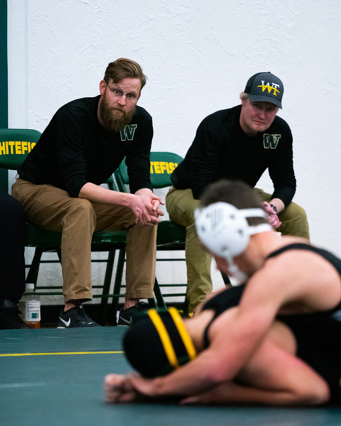 Head coach Ryan Boyle and assistant coach Danny Neff watch a Whitefish wrestler Thursday at Whitefish High School. (Daniel McKay/Whitefish Pilot)