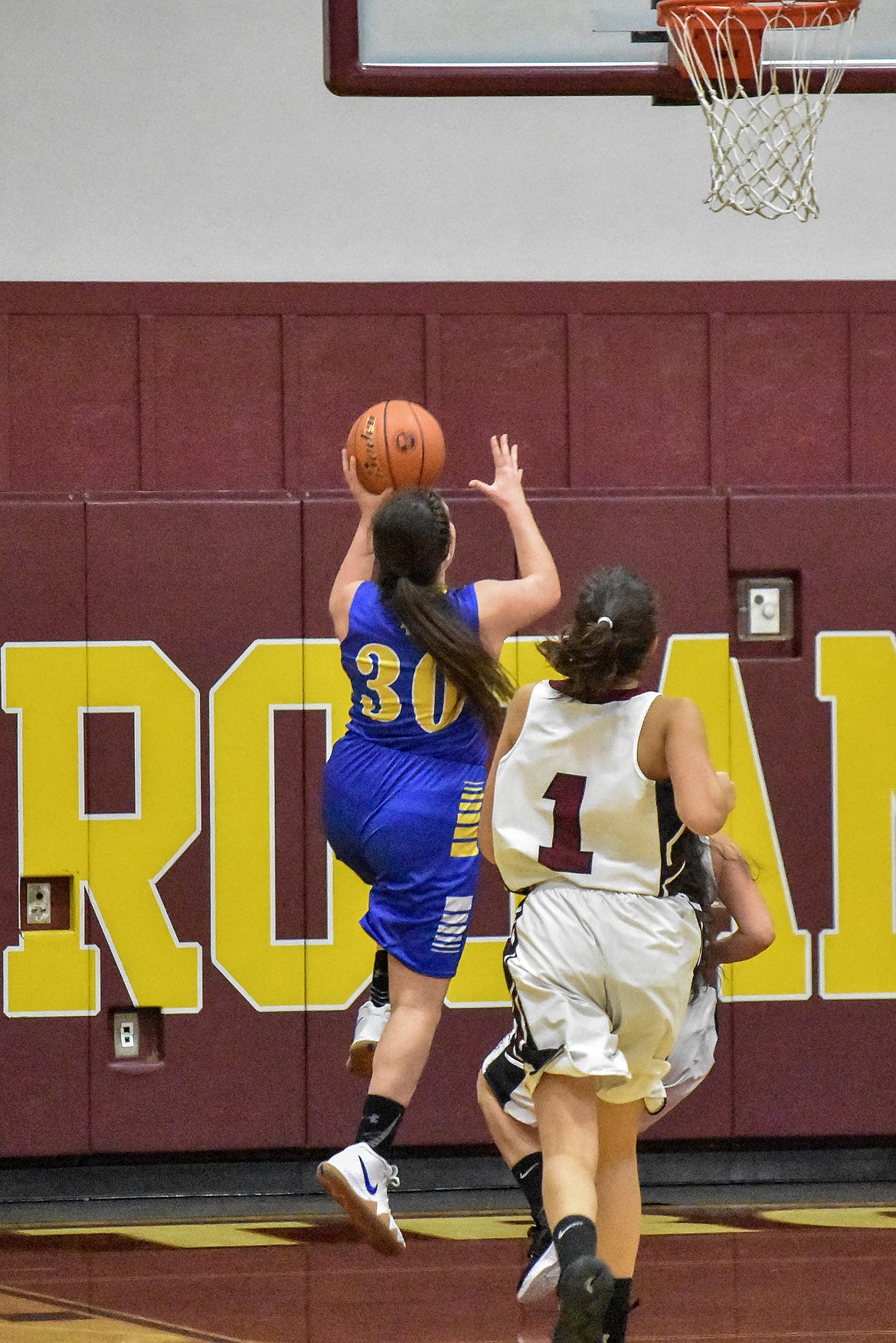 Libby senior Sammee Bradeen goes in for a layup with Troy sophomore Talise Becquart at her heels in the third quarter against Troy at Troy Tuesday. (Ben Kibbey/The Western News)