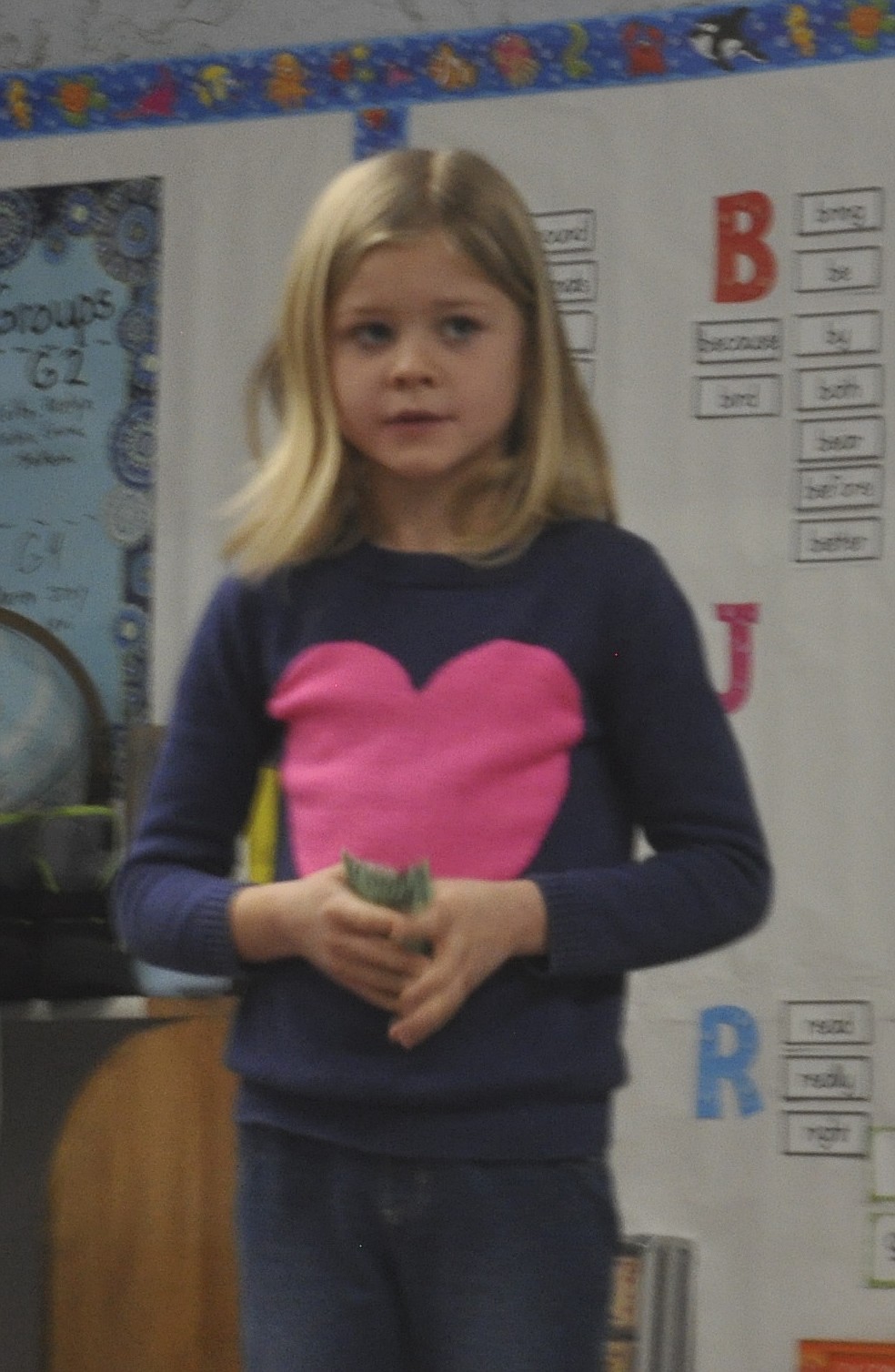 Kylie Cox, 8, a second grade student at Charlo Elementary, contemplates an item during an auction her teacher, Danielle Frisk, held just before Christmas.