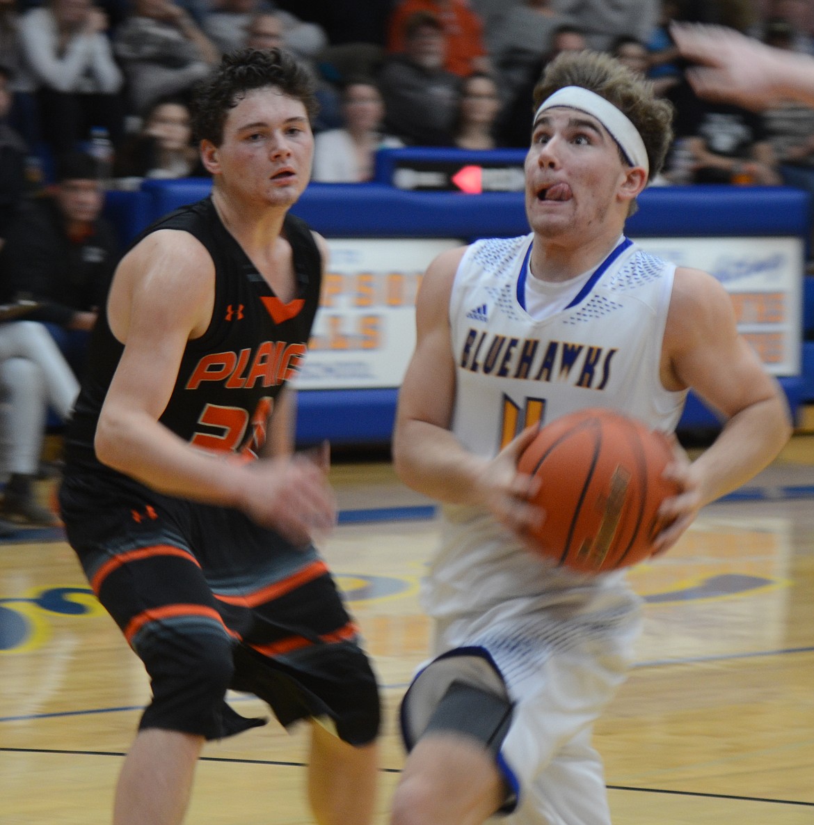 Thompson Falls junior Ryan Schraeder (4) takes the ball to the hoop past Matt McCracken of Plains during action Thursday, Dec. 18. McCracken netted 12 points in Plains&#146; 50-37 win while Schraeder finished with eight points for the Blue Hawks. (Joe Sova/Clark Fork Valley Press)