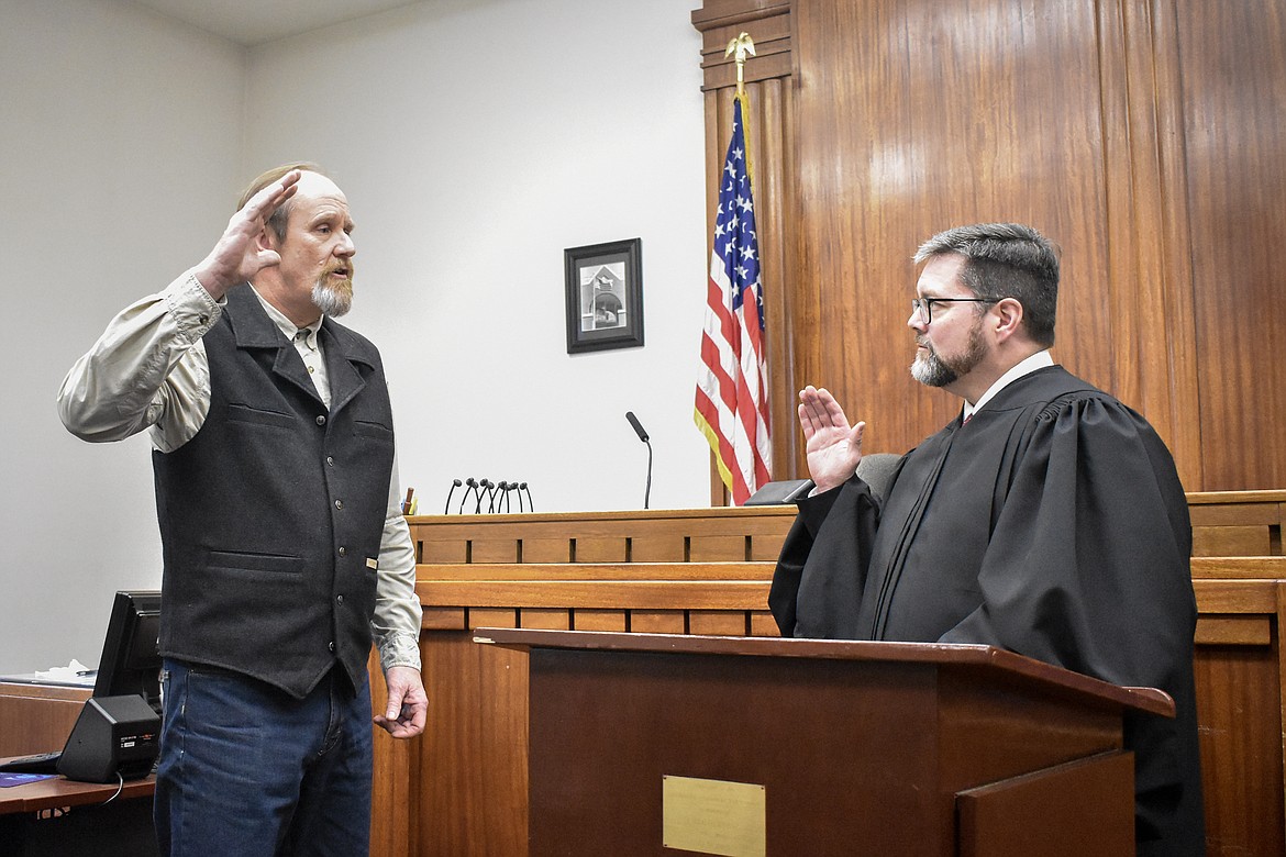 Montana 19th Judicial District Judge Matt Cuffe swears in Lincoln County Justice of the Peace Jay Sheffield in the County Courthouse Wednesday. (Ben Kibbey/The Western News)