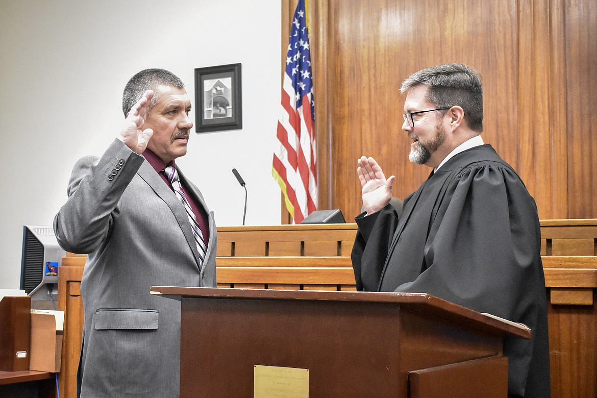 Montana 19th Judicial District Judge Matt Cuffe swears in Lincoln County Sheriff Darren Short in the County Courthouse Wednesday. (Ben Kibbey/The Western News)