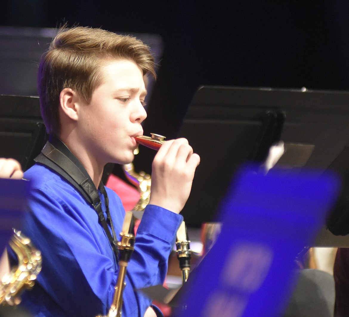 Normally a saxophone player eighth-grader Henry Siegmund plays the kazoo during &#147;The Chipmunk Song&#148; performance at the Whitefish Middle School winter band concert. (Heidi Desch/Whitefish Pilot)