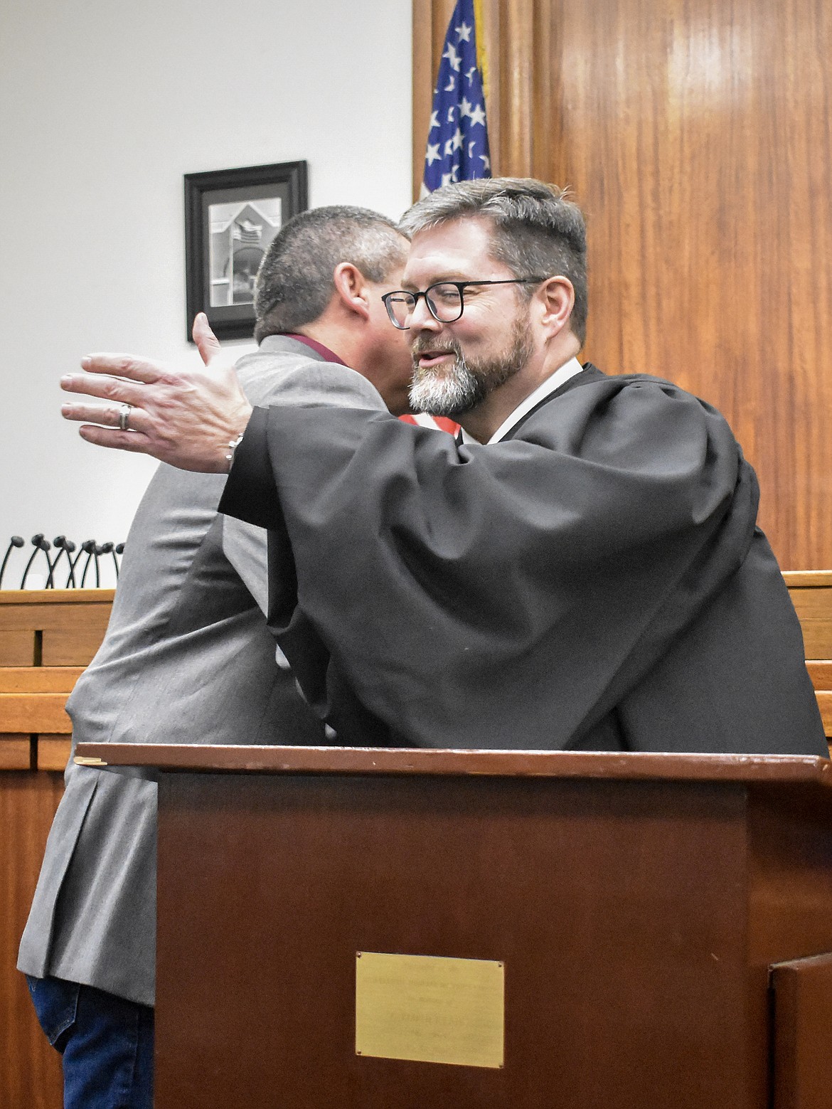 Montana 19th Judicial District Judge Matt Cuffe congratulate new Lincoln County Sheriff Darren Short after Short&#146;s swearing in at the County Courthouse Wednesday. (Ben Kibbey/The Western News)