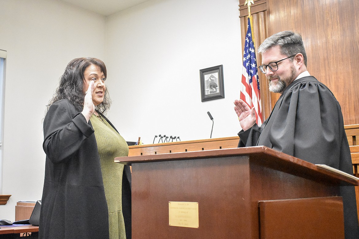 Montana 19th Judicial District Judge Matt Cuffe swears in Lincoln County Attorney Marcia Boris in the County Courthouse Wednesday. (Ben Kibbey/The Western News)