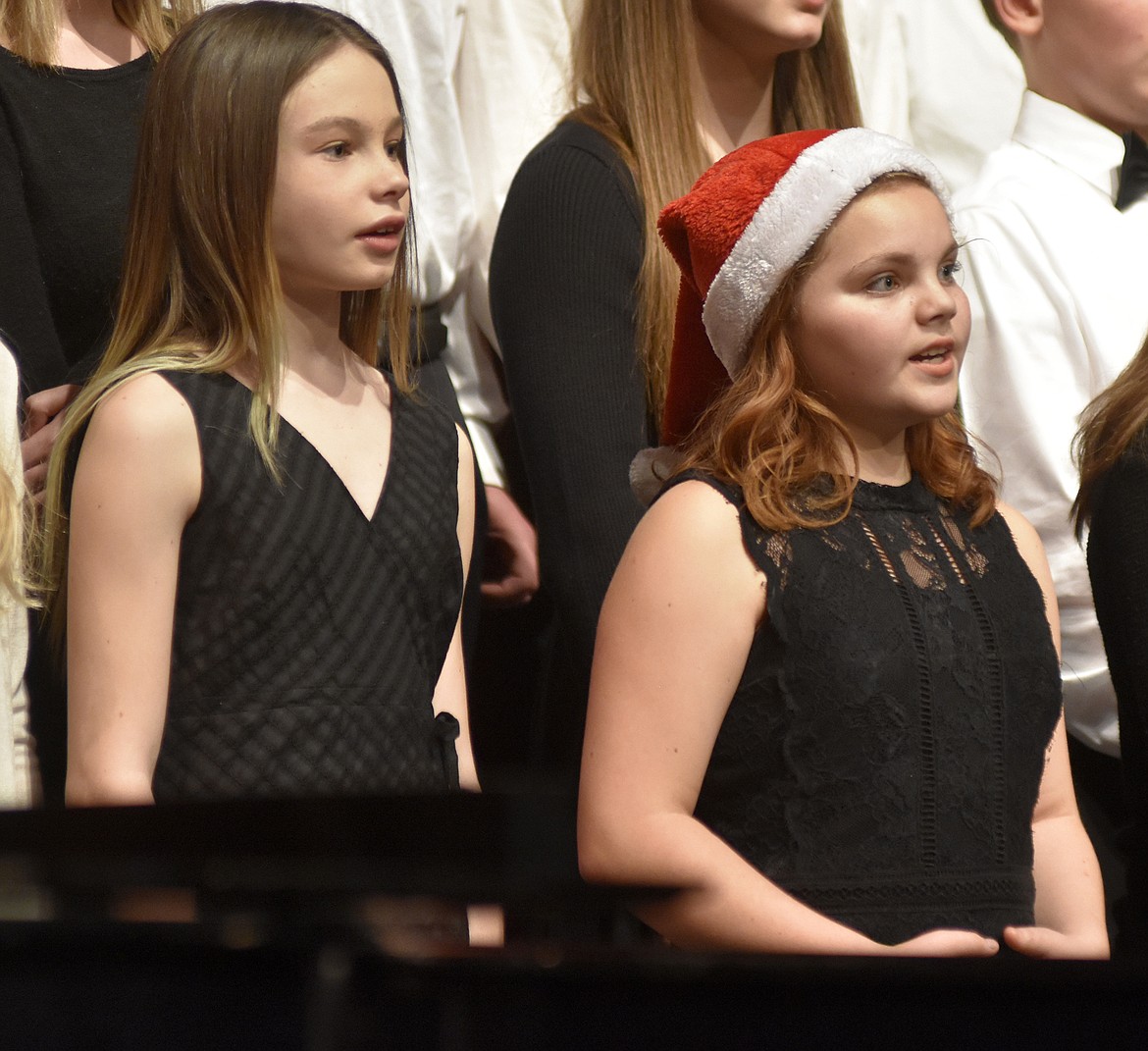 Whitefish Middle School choir members Tove Davies and Araya Nieves sing &#147;Jingle Bell Rock&#148; during the Whitefish Schools choir concert last week at the Whitefish Performing Arts Center. (Heidi Desch/Whitefish Pilot)