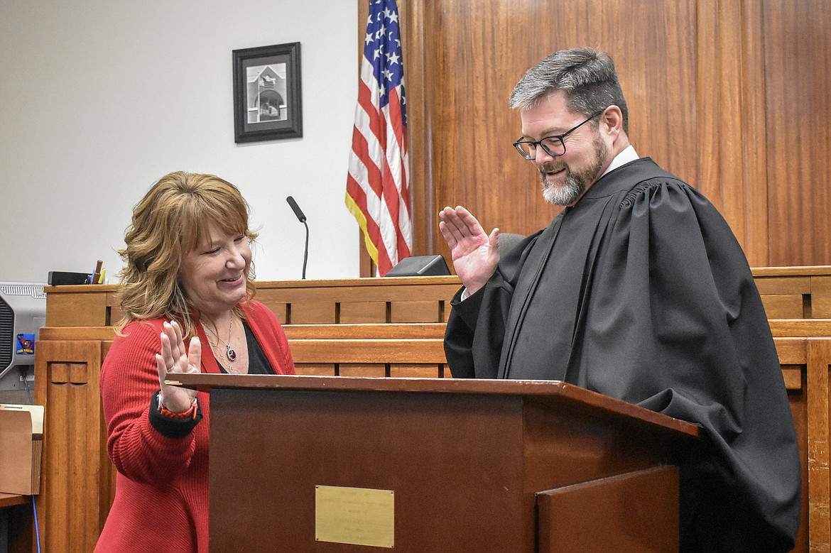 Montana 19th Judicial District Judge Matt Cuffe swears in Lincoln County Clerk and Recorder/Auditor/Assessor/Surveyor Robin Benson in the County Courthouse Wednesday. (Ben Kibbey/The Western News)