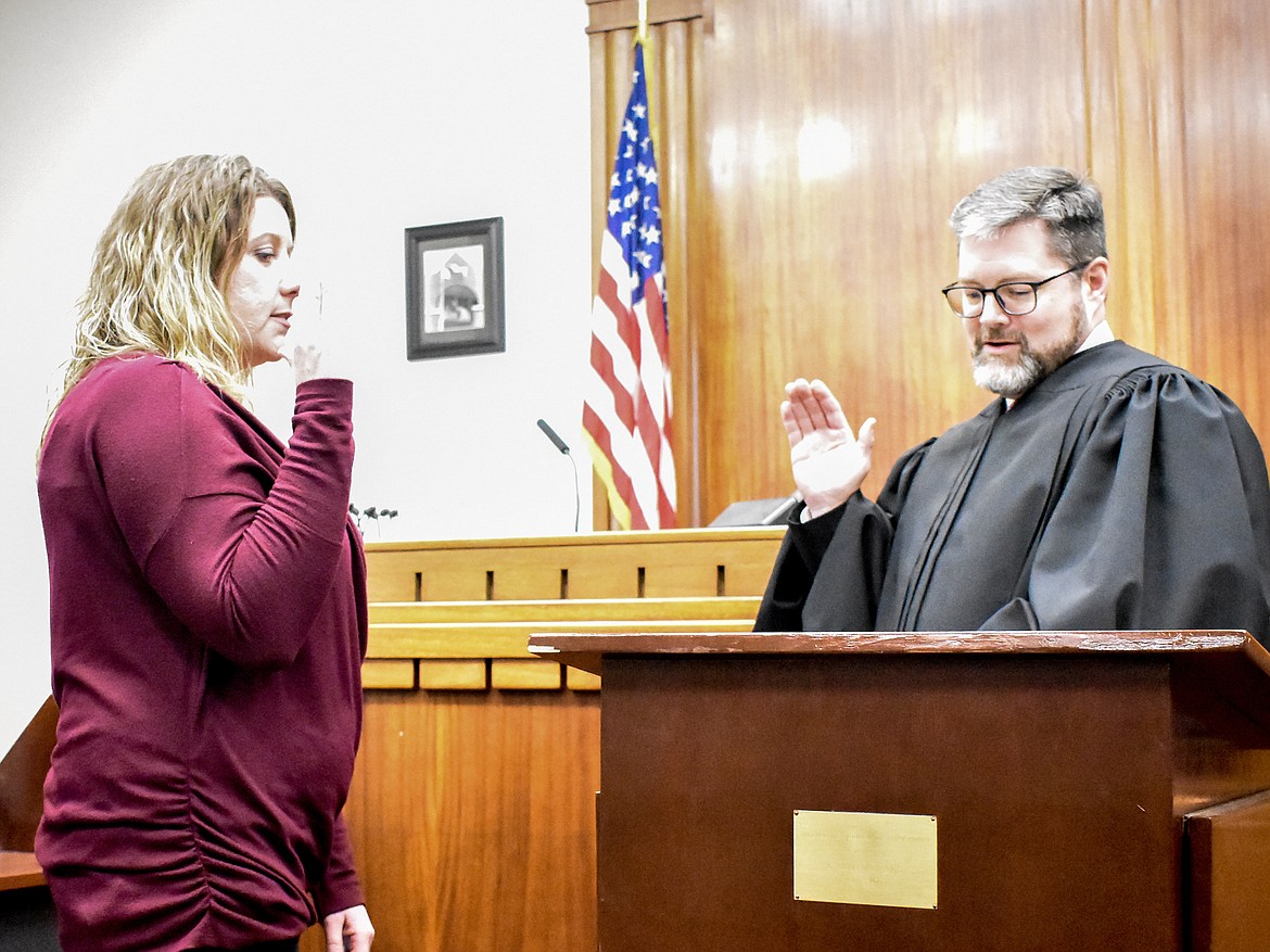 Montana 19th Judicial District Judge Matt Cuffe swears in Lincoln County Treasurer/Superintendent of Schools Sedaris Carlberg in the County Courthouse Wednesday. (Ben Kibbey/The Western News)