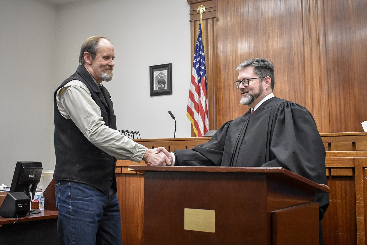 Montana 19th Judicial District Judge Matt Cuffe congratulates Lincoln County Justice of the Peace Jay Sheffield after his swearing in at the County Courthouse Wednesday. (Ben Kibbey/The Western News)