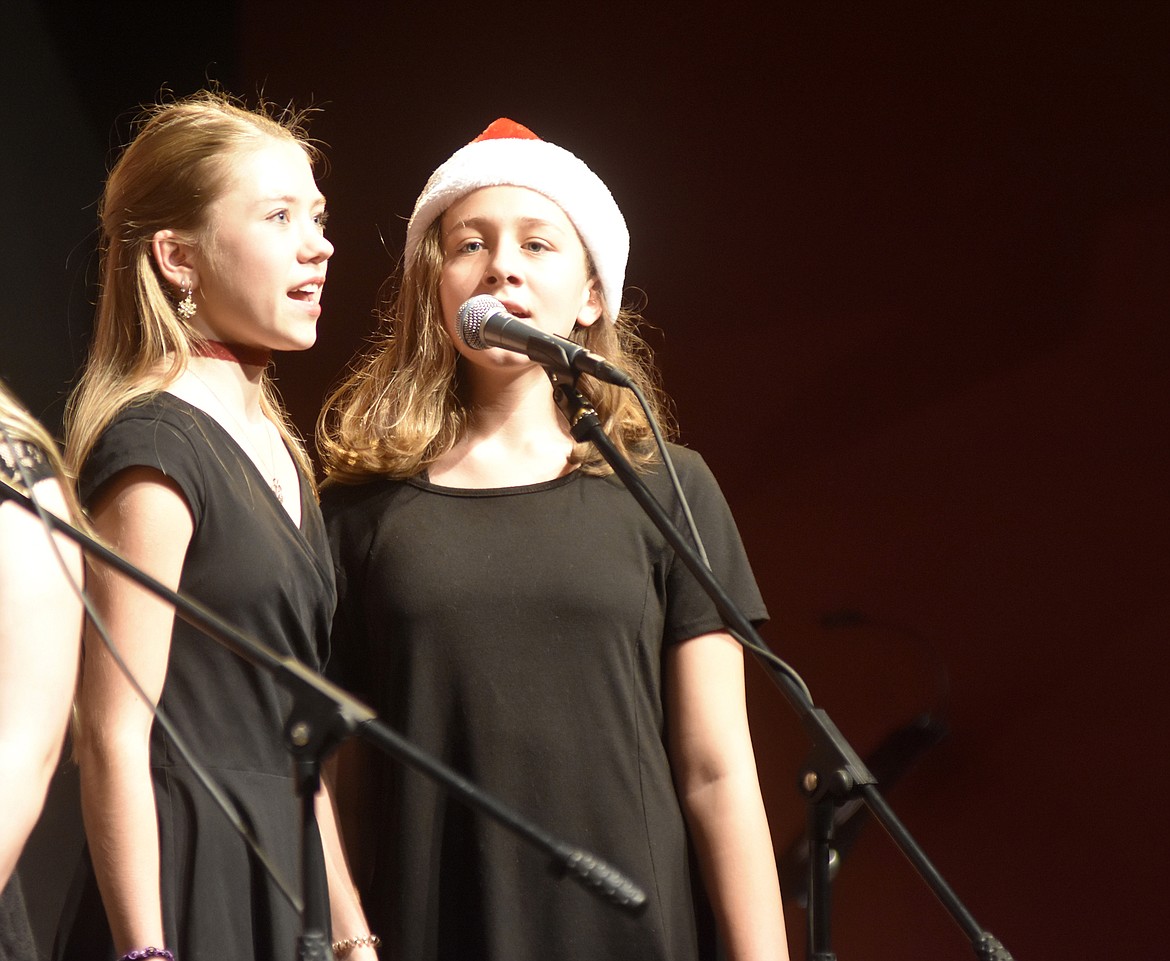 Jenna Peacock and Rachael Drucker sing as part of a quartet during &#147;Jingle Bell Rock&#148; during the middle school choir&#146;s performance at the Whitefish Schools holiday choir concert. (Heidi Desch/Whitefish Pilot)