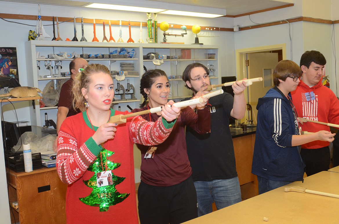 Plains High School students, from left, Dakota Butcher, Cree Lulack, Wyatt Karr and others shoot pop guns loaded with a cork during the Brain Bash. The events were held to celebrate the holiday break. (Joe Sova/Clark Fork Valley Press)