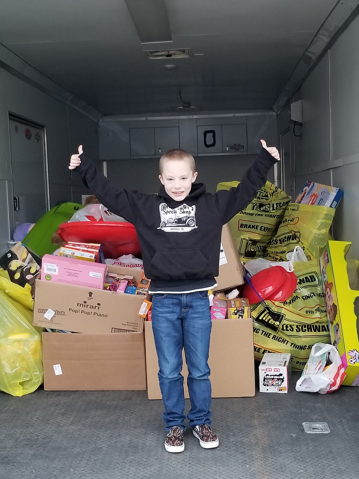 Carter Colby, 8, with the toys he donated to the Toys for Tots drive this month. (Photo provided)